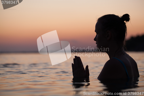 Image of Woman in water during pray or meditation