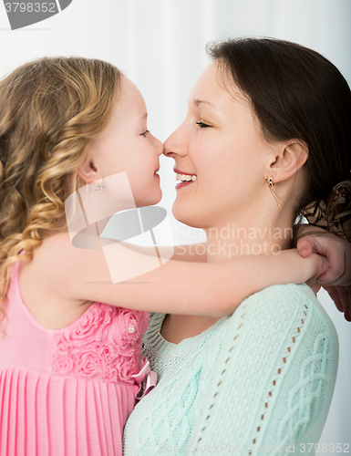 Image of Mother and daughter touching with noses