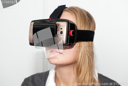 Image of Woman wearing VR-headset over white background