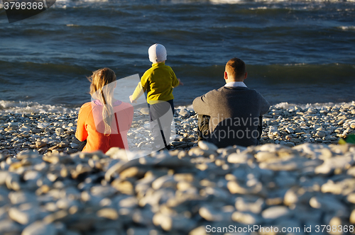 Image of Family of three on pebble beach