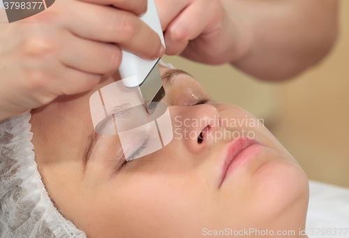 Image of Woman under procedure of ultrasonic facial cleaning