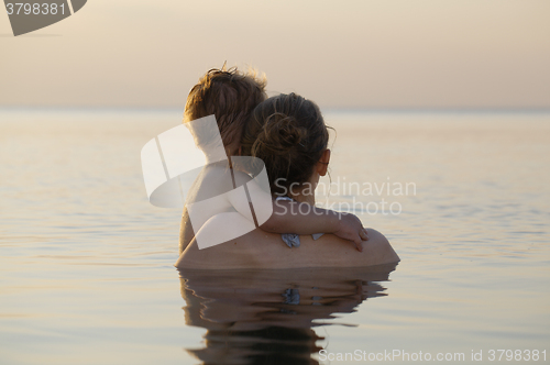 Image of Mother and son watching the sunset