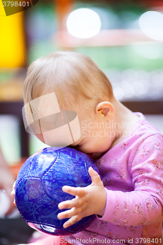 Image of Cute little baby playing with a ball