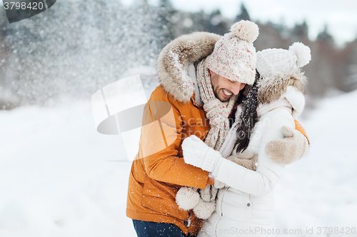 Image of happy couple hugging and laughing in winter