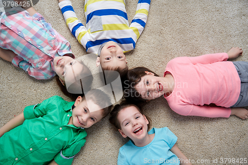 Image of happy smiling little children lying on floor