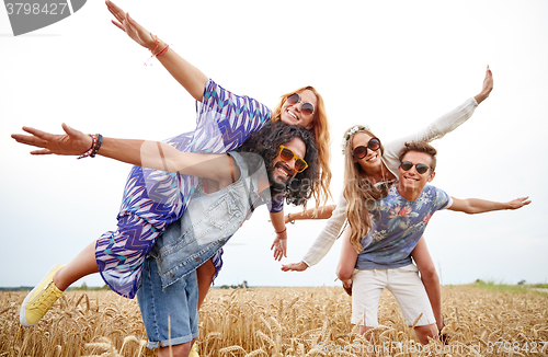 Image of happy hippie friends having fun on cereal field