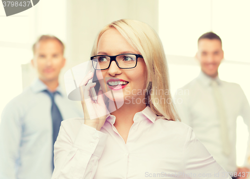 Image of smiling businesswoman calling on smartphone