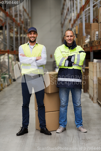 Image of men in uniform with boxes at warehouse