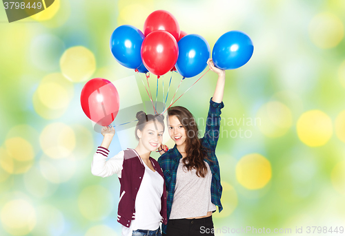 Image of happy teenage girls with helium balloons