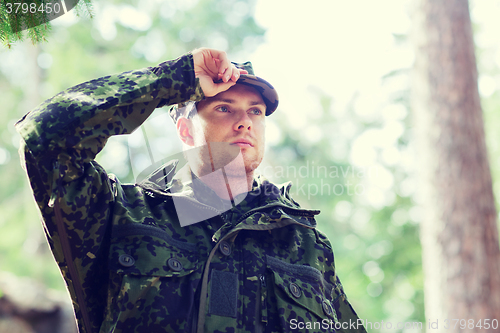 Image of young soldier or ranger in forest
