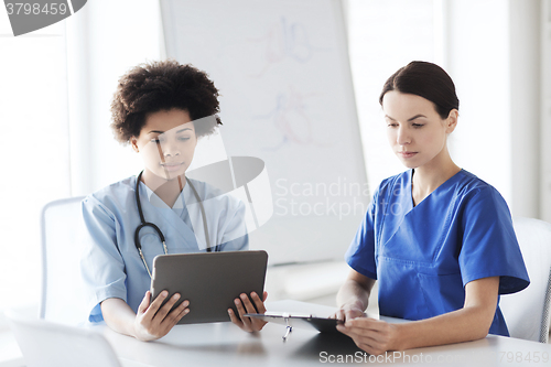 Image of doctors with tablet pc meeting at hospital