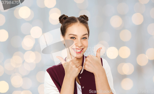 Image of happy smiling teenage girl showing thumbs up