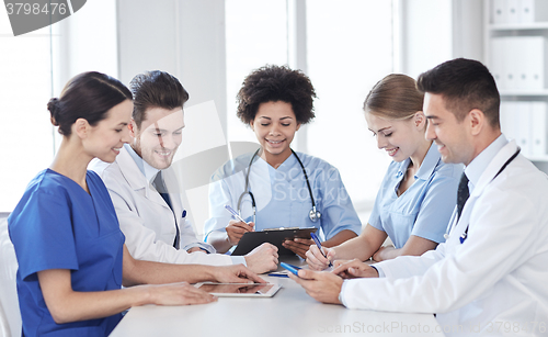 Image of group of happy doctors meeting at hospital office