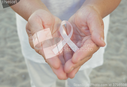 Image of Hands holding pink ribbon