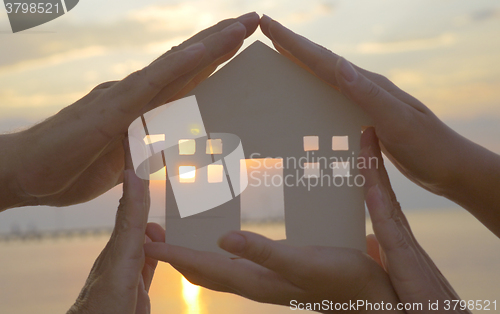 Image of Hands on cut out house diagram