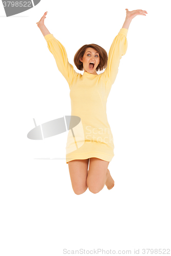 Image of Adult woman in yellow dress jumping
