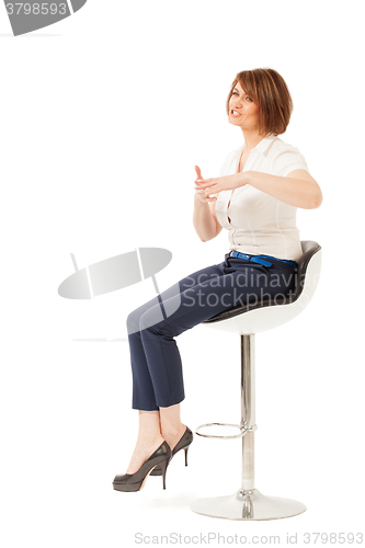 Image of Elegant businesswoman talking while sitting on chair