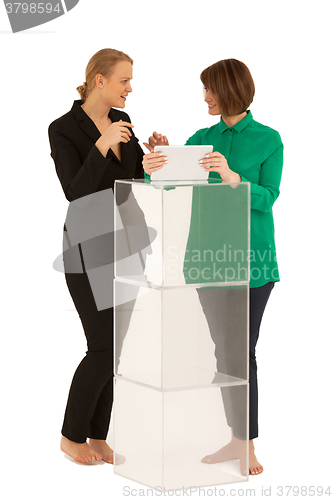 Image of Two women looking to each other while talking