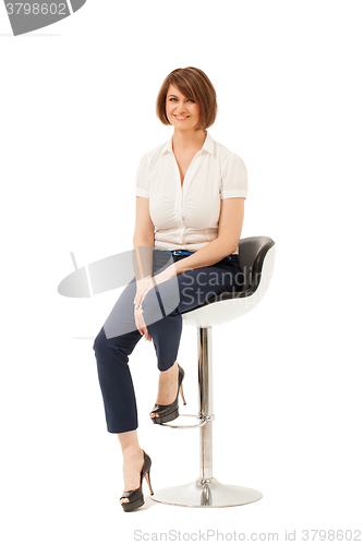 Image of Portrait of smiling businesswoman on chair