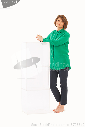 Image of Adult woman near glass stand