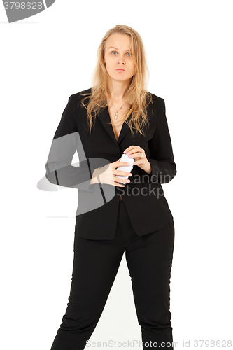 Image of Businesswoman looking at camera while holding smartphone 