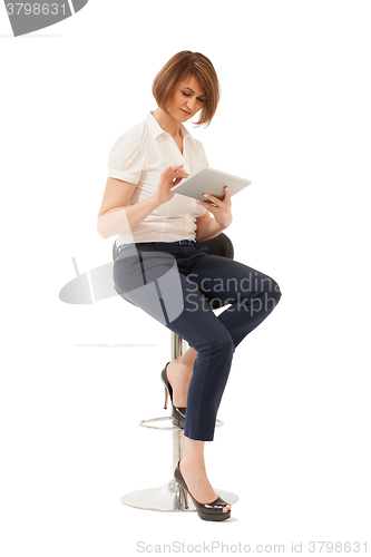 Image of Businesswoman using tablet while sitting on chair