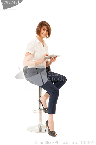 Image of Portrait of adult woman with tablet looking at camera