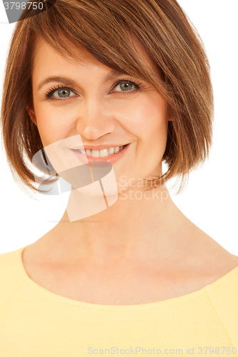 Image of Adult brunette in yellow smiling at camera