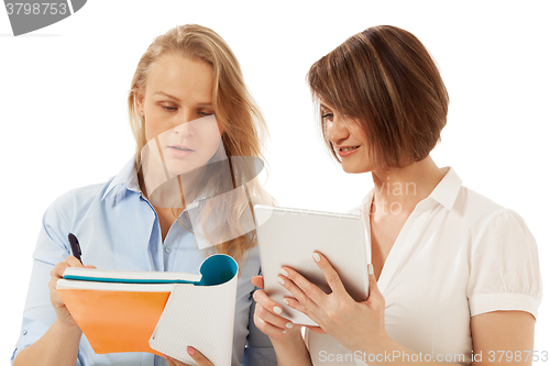 Image of Woman showing something in her folder to colleague