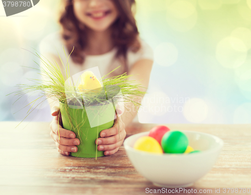 Image of close up of girl holding pot with easter grass