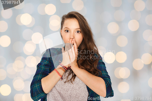 Image of scared teenage girl over holidays lights