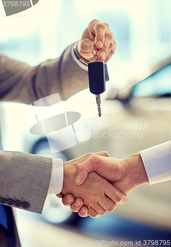 Image of close up of handshake in auto show or salon