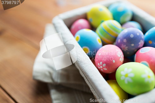 Image of close up of colored easter eggs in basket