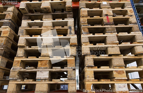 Image of wooden cargo pallets storing at warehouse shelves