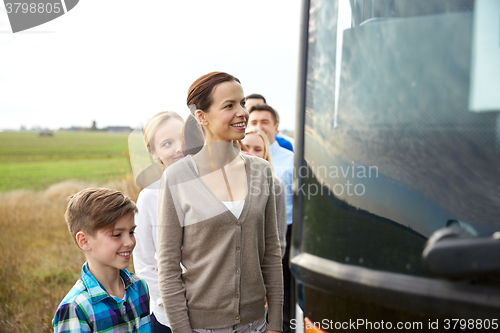 Image of group of happy passengers boarding travel bus