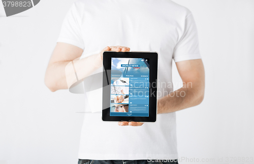 Image of close up of man with business news on tablet pc