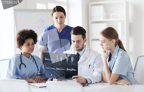 Image of group of doctors discussing x-ray image