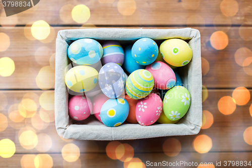 Image of close up of colored easter eggs in basket