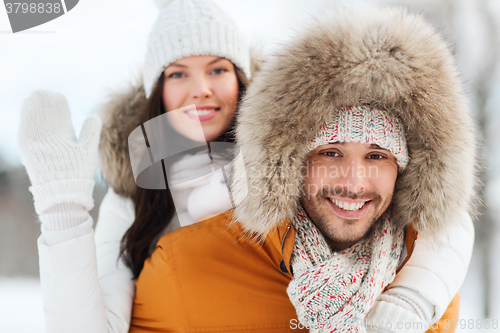 Image of happy couple having fun over winter background