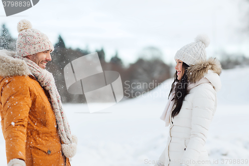 Image of happy couple walking over winter background