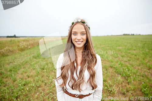 Image of smiling young hippie woman on cereal field