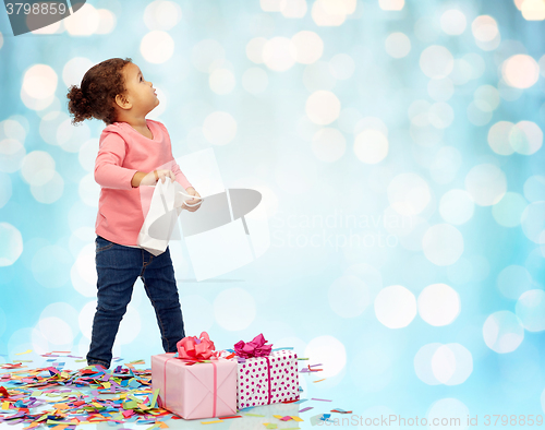 Image of happy little baby girl with birthday presents