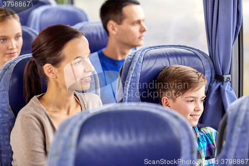 Image of happy family riding in travel bus