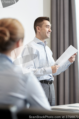 Image of smiling businesspeople meeting in office