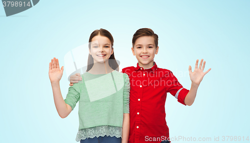 Image of happy boy and girl waving hand