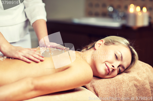 Image of close up of woman lying and having massage in spa