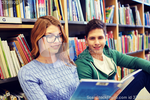 Image of close up of happy students reading book in library