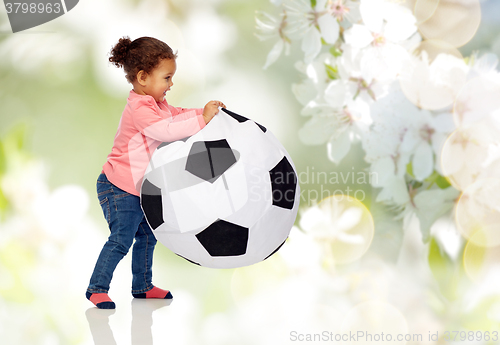Image of happy mulatto little baby girl playing with ball
