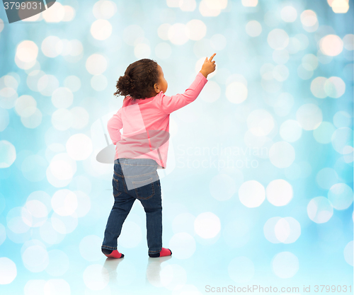 Image of african baby girl pointing finger to something