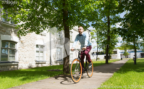 Image of happy young hipster man riding fixed gear bike